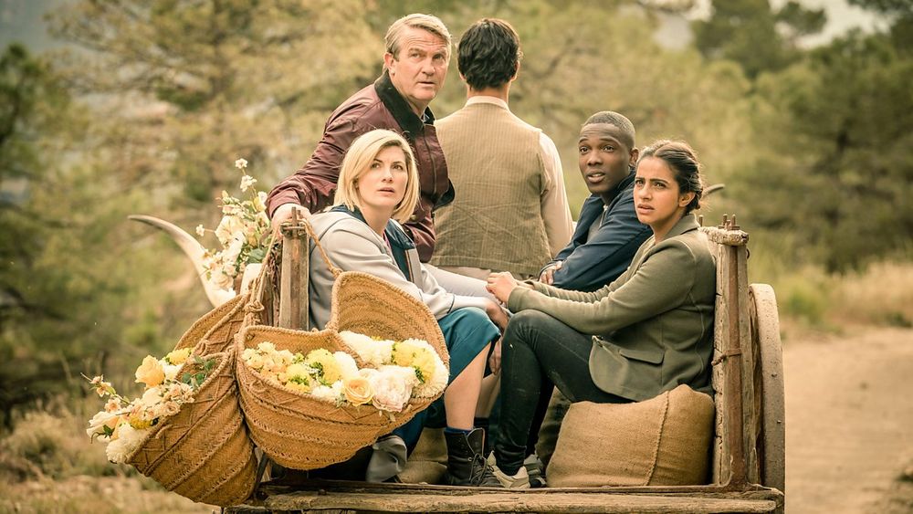 Demons of the Punjab - 13th Doctor, Yasmin Khan, Ryan Sinclair, Graham O'Brien sat in a cart