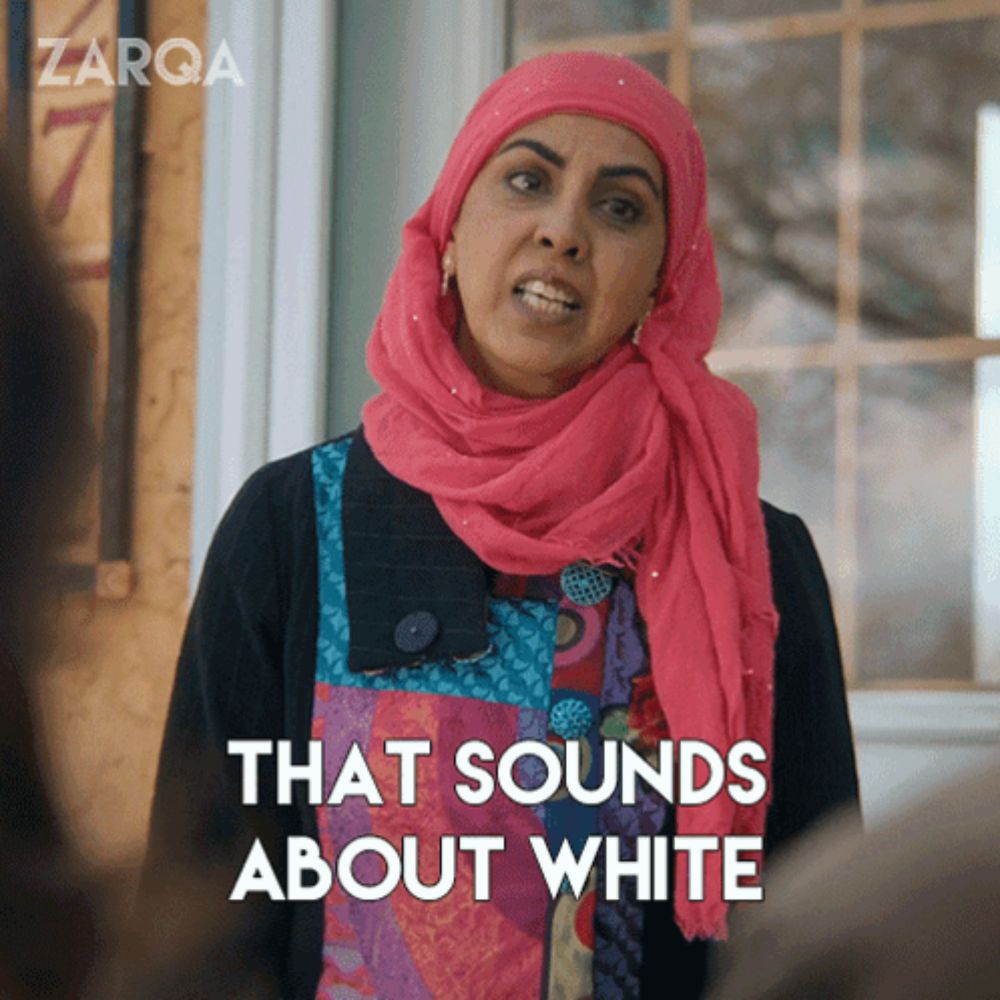 a woman wearing a pink scarf and a black shirt says that sounds about white