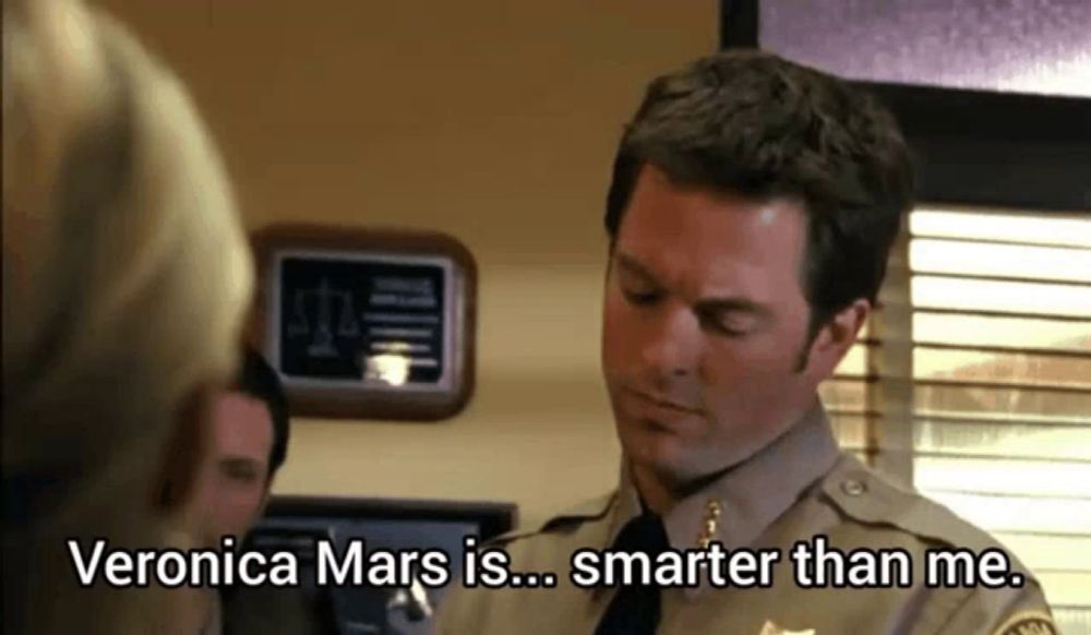 a man in a sheriff 's uniform is talking to a woman and says veronica mars is smarter than me