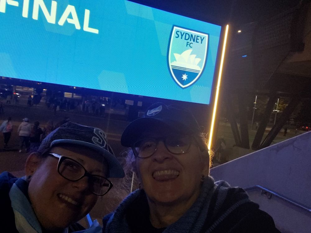 Me and Dianne underneath the winning signage outside the ground.