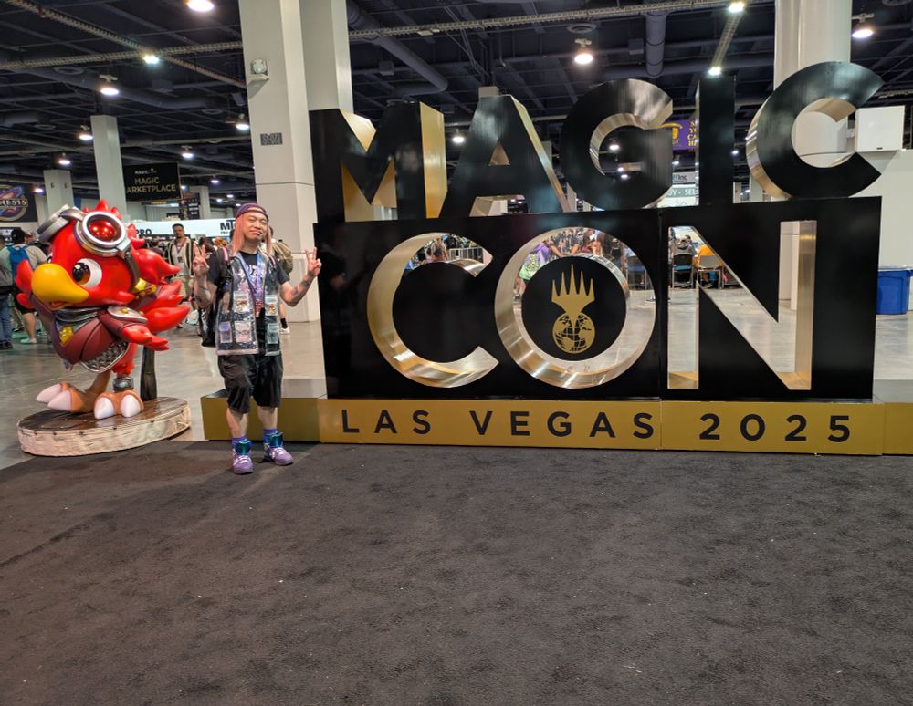 Guy with MagicCon sign and red Chocobo 