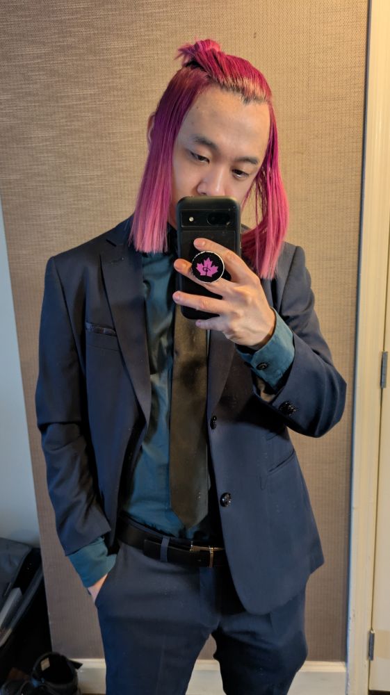 Dude with pink hair and dark navy suit 