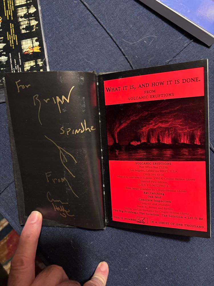 A black page opposite the front page of WHAT IT IS, AND HOW IT IS DONE by Crispin Hellion Glover. The inscription in gold ink reads:
“For Brian
Spindle
(A drawing of a spindle)
From
Crispin
Hellion”