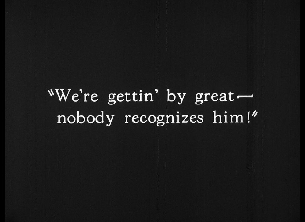 Intertitle from "The Clash of the Wolves". Text reads "We're gettin' by great - nobody recognizes him!" 