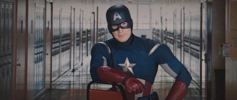 Captain America leans over a chair to give a lecture