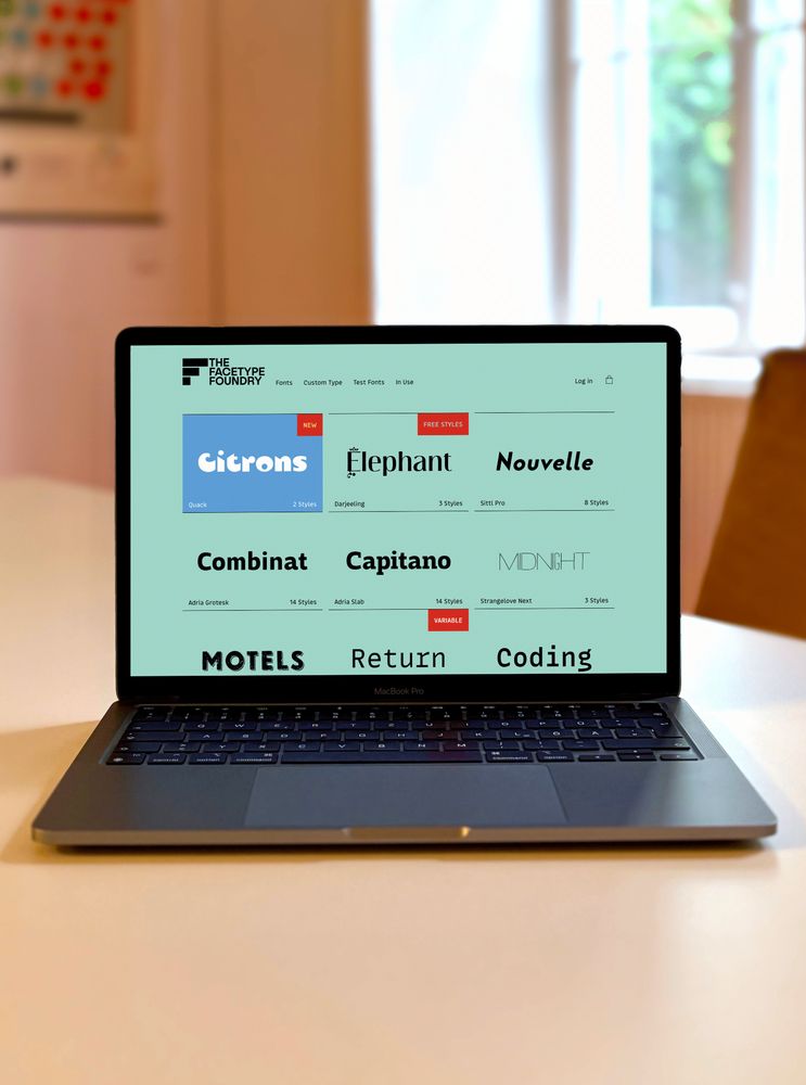 Laptop on a table showing our website.
