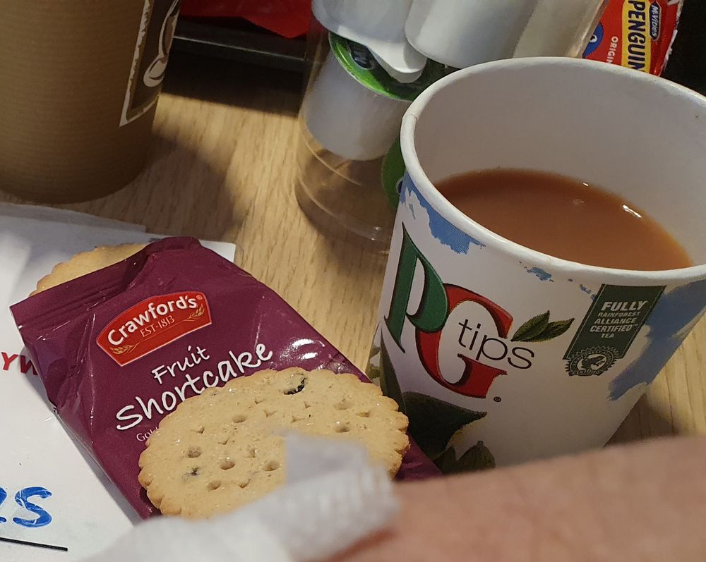 A pack of Crawfords Fruit Shortcake biscuits and a cup of PG Tips tea on the refurbishment table at a blood donation session.
