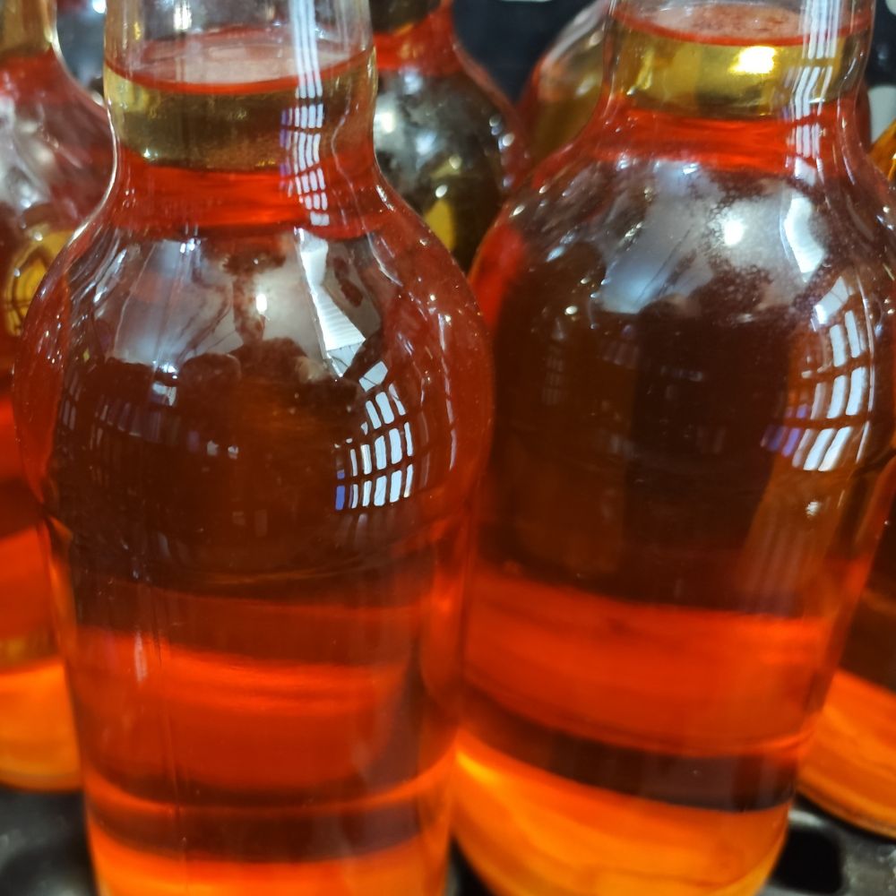 A group of bottles of cider ready for labelling, showing off clarity & natural colour. 