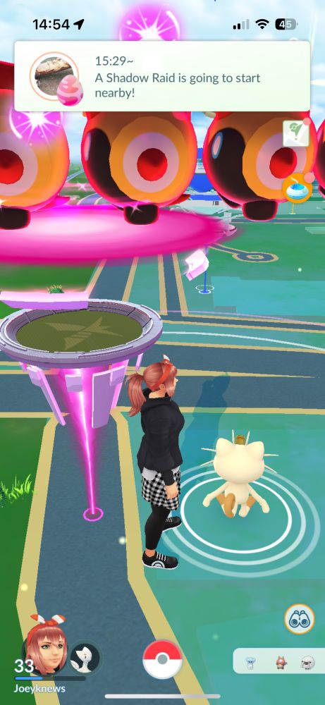 Screenshot of the mobile game Pokémon Go, showing a green hued map of the user’s local area. A human avatar with a ginger ponytail faces to the right, while a small cat-like creature sits near their feet. A pink-hued marker with a big orange caterpillar on top hovers over the human’s head. The Pokémon Go UI is shown around the outer edge of the screenshot. 