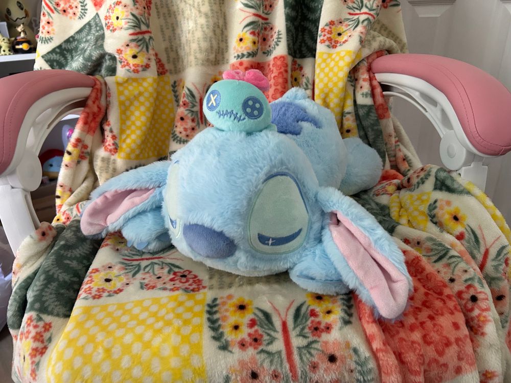 pastel stitch plush sleeping with scrump on his head