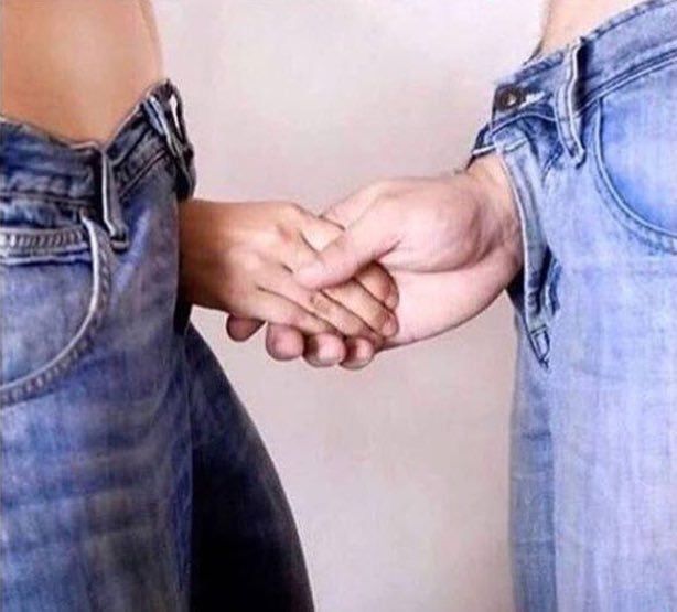 Two people shaking hands but their hands are coming out of the fly of their jeans