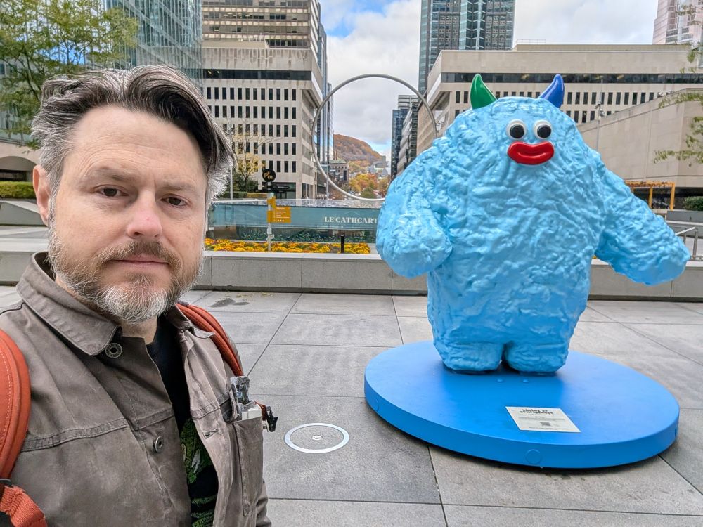 Account holder in Montreal in front of... I have no idea what the friendly blue yeti thing is...