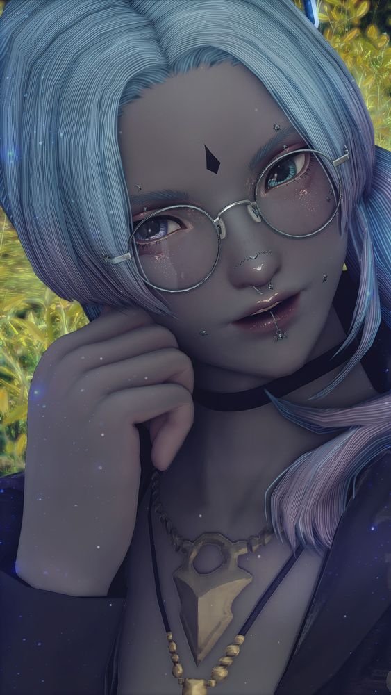 a petite miqo'te man with grayish skin and teal hair tipped with purple, which has been tied in a side ponytail. he has mismatched eyes, with his right being purple and the left being blue. he is wearing round glasses with a slim silver frame, a choker and two other necklaces, and a long-sleeved purple shirt; he has one hand curled loosely near his face, and he is smiling at the viewer, lips slightly parted. he has matching eyebrow piercings, surface piercings over his cheekbones, a chain over his nose, a nose ring, two dimple piercings, and a lip ring, all silver and featuring moon and star elements.