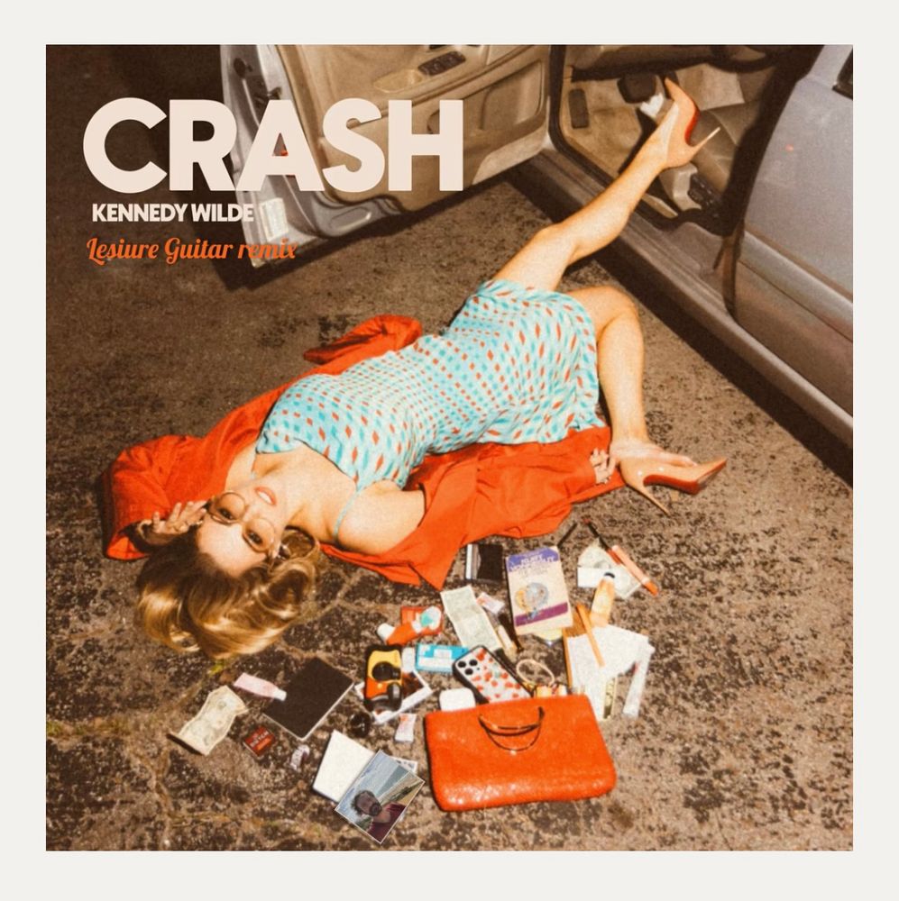 Album cover. A woman is lying next to a car, the contents of her bag scattered around her.
