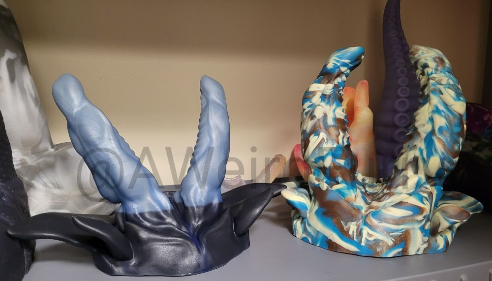 Bad Dragon beta shark next to a Bad Dragon Bruce