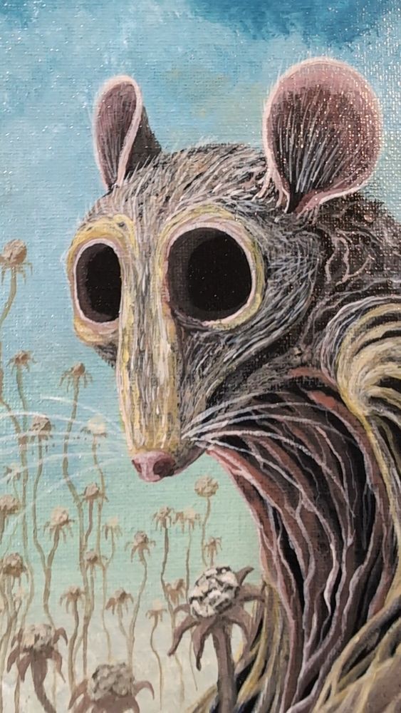 A close up of the rat's face against a dull sky.