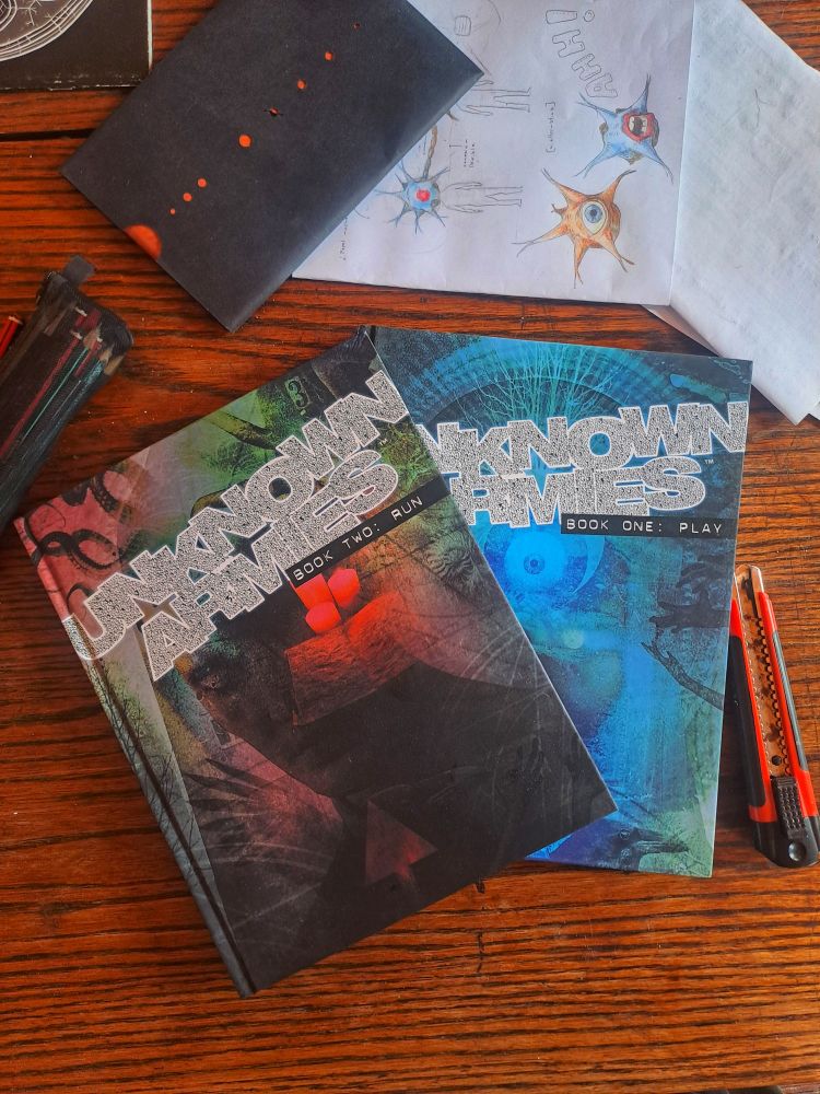 Photo of the two core Unknown Armies 3rd Edition books.