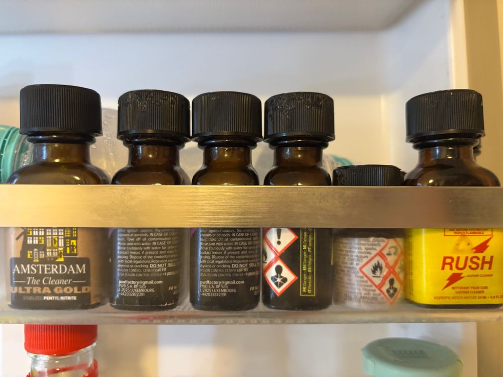 Six bottles of poppers in a fridge