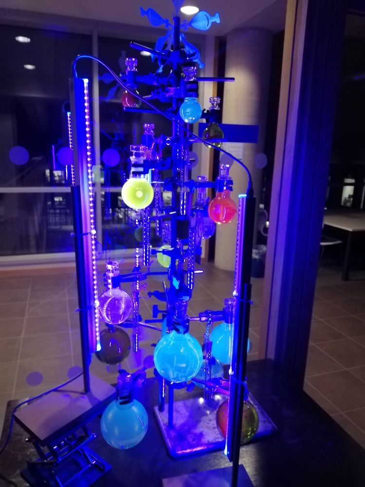Fluorescent chemistree showing different coloured solutions that fluoresce under UV illumination 