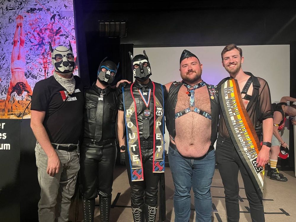 Delta standing with friends and family at Illinois Bear Contest: Alpha Artemis Lykós, Beta Audeamus Surge, Delta, Illinois Pet 2024 Artemis Lokison, North American Cub 2025 TooMuchNeon