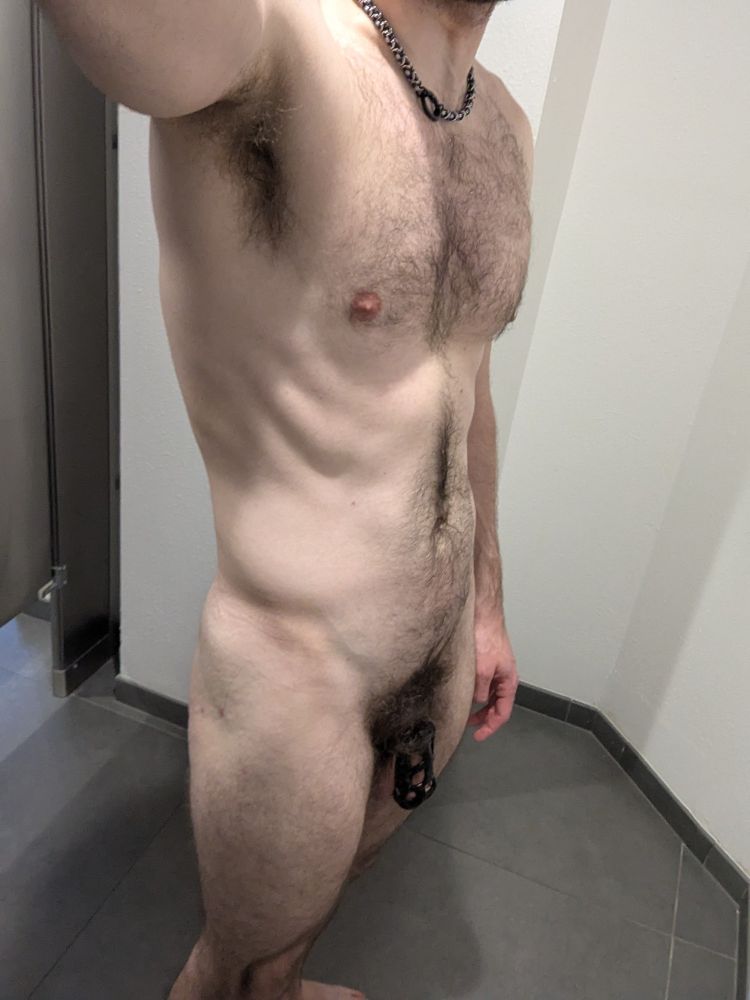 Delta posing in the bathroom at the gym, wearing nothing but a collar and a chastity cage