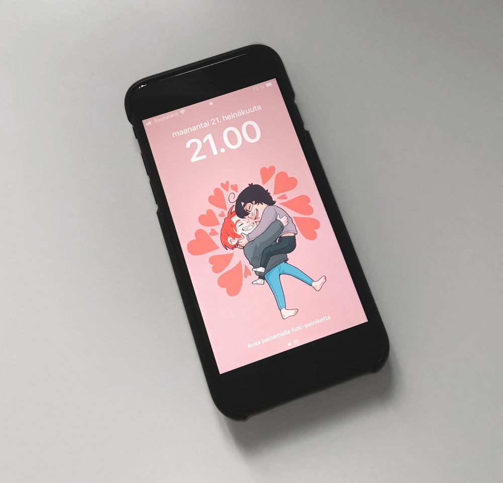 A photo of my phone with the wallpaper on the lock screen.