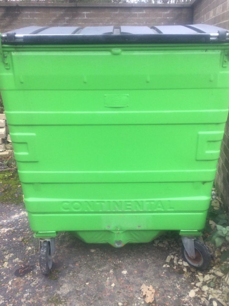 A large, bright green, wheeled bin with the name “Continental” embossed on the base. 