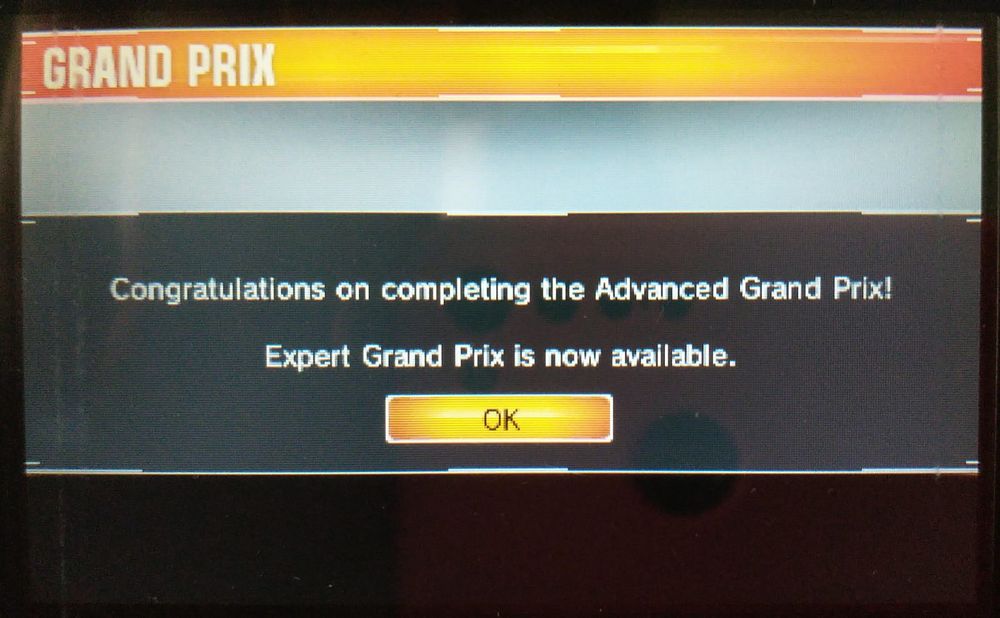 Off-screen photo of Ridge Racer 3D on Nintendo 3DS
"Congratulations on completing the Advanced Grand Prix! Expert Grand Prix is now available."