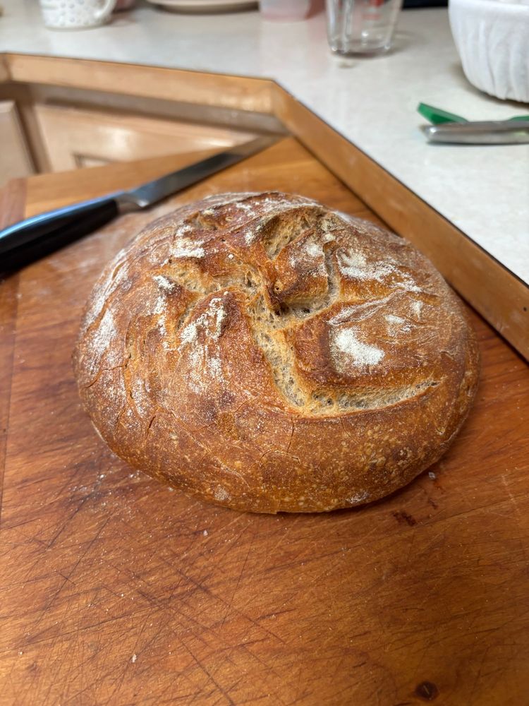 Dark brown boule of sourdough bread