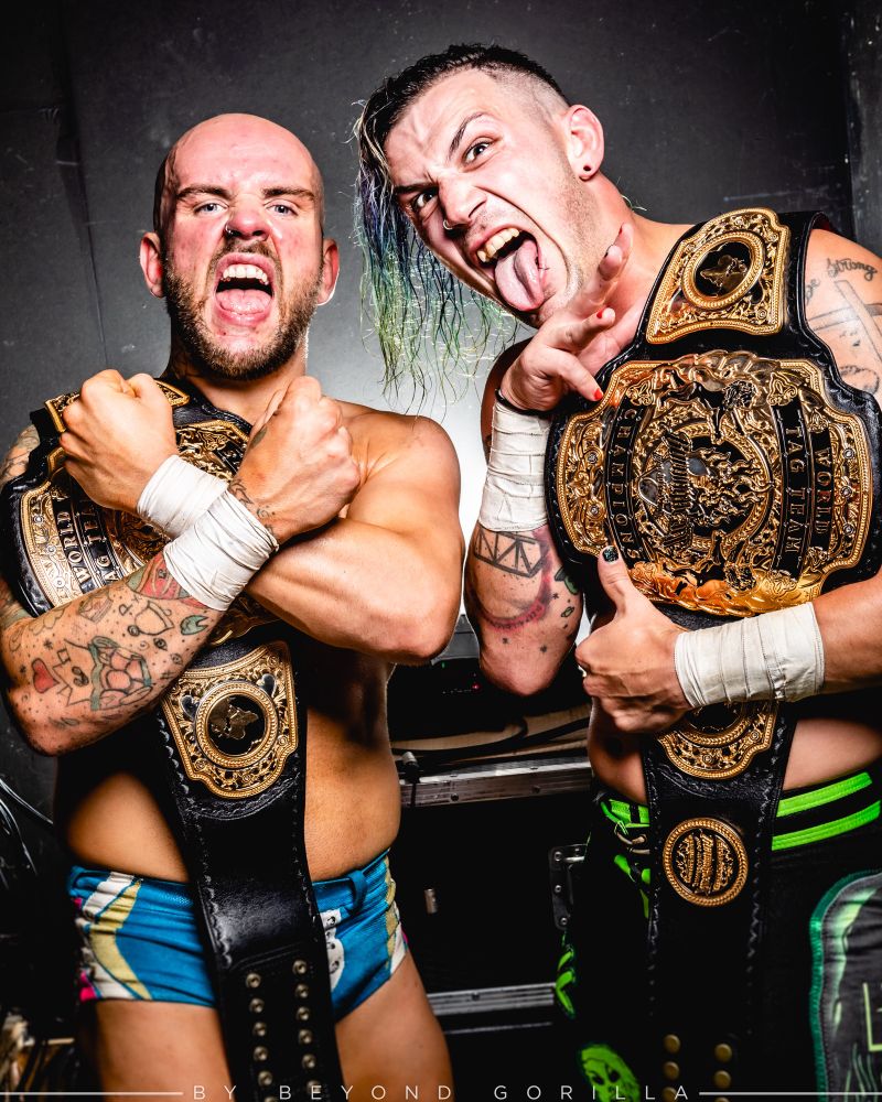 A Zackary Wentz and Robbie X portrait By Beyond Gorilla featuring the burning heart tag team championships