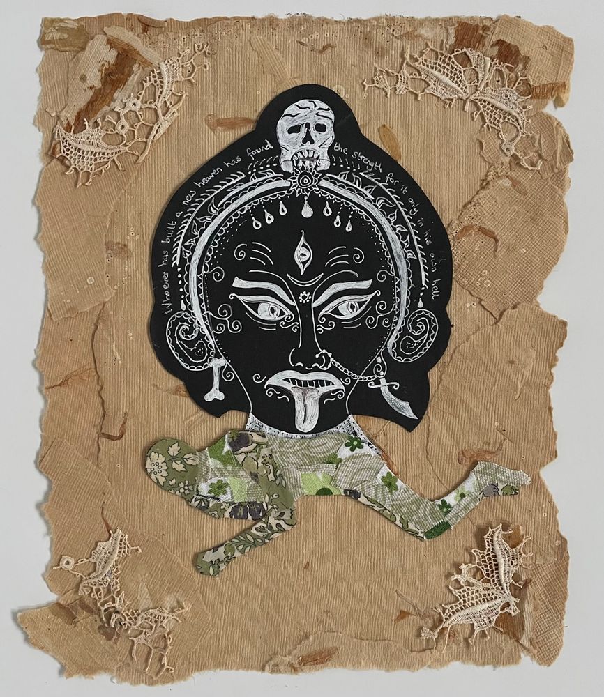 Mixed media collage on tan-coloured old, textured, torn paper with vintage lace in the corners. At the centre is a white drawing on black paper of the fearsome face of the Hindu goddess Kali-Ma. Below this is a person lying down, created from tiny scraps of green floral fabrics. 