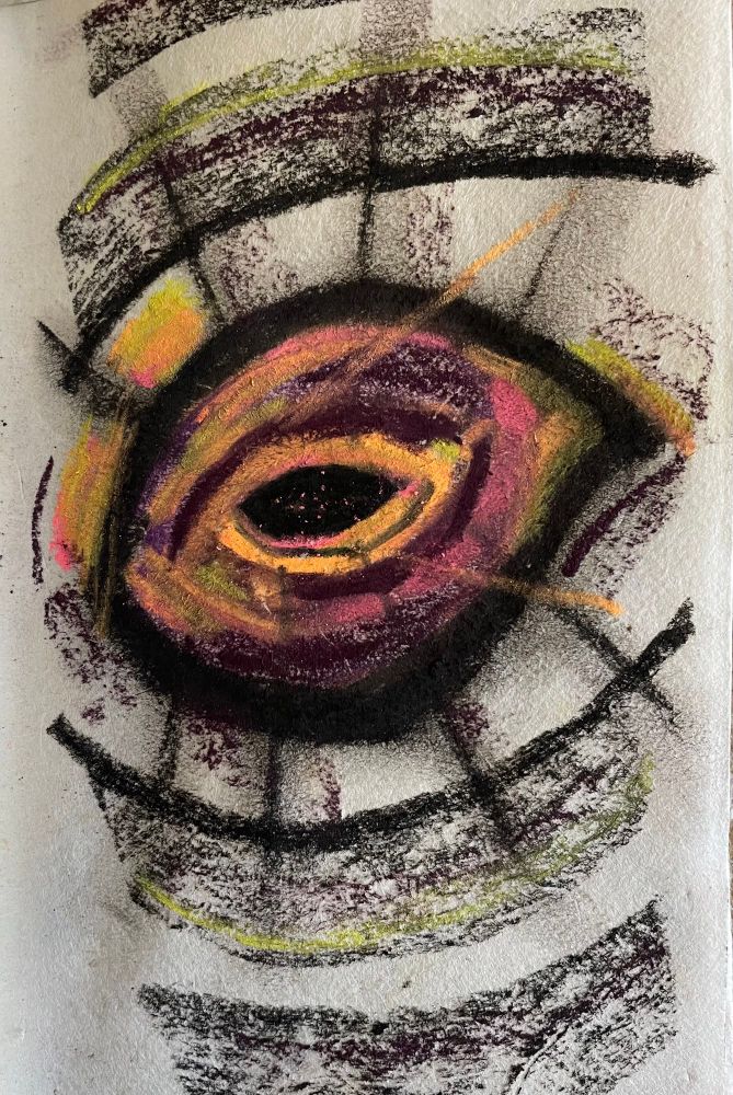 A loose sketch on white paper using soft chalk pastels depicts an abstract eye in black with neon orange, pink and yellow blended layers surrounding it as well as a deep bruised maroon blended in. More sweeping black in soft wide lines and hard deep lines echo the shape of the eye. Black and neon orange straight lines radiate outwards from the centre of the eye in conflicting directions. The black centre of the eye is speckled with neon orange dots, almost like looking into a universe of stars in deep space. 