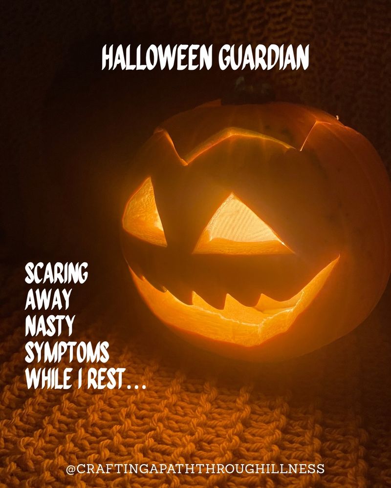 A grinning carved pumpkin is lit from within and sitting in the dark on a textured knitted blanket. White text reads: 
HALLOWEEN GUARDIAN
SCARING AWAY NASTY SYMPTOMS WHILE I REST...

@CRAFTINGAPATHTHROUGHILLNESS
