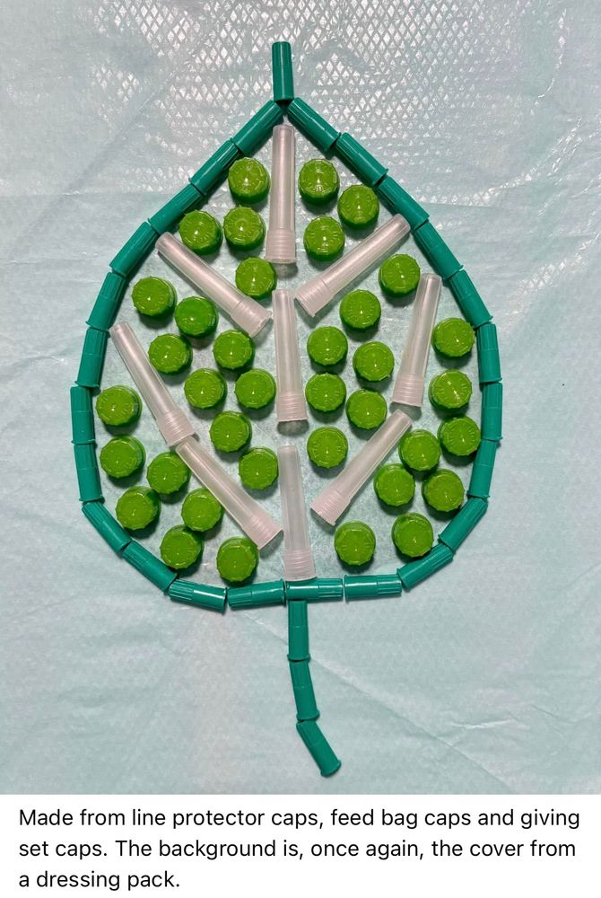 A stylised leaf is depicted using bright green, jade green and transparent line protector caps, feed bag caps and giving set caps. The background is a pale turquoise cover from a dressing pack.