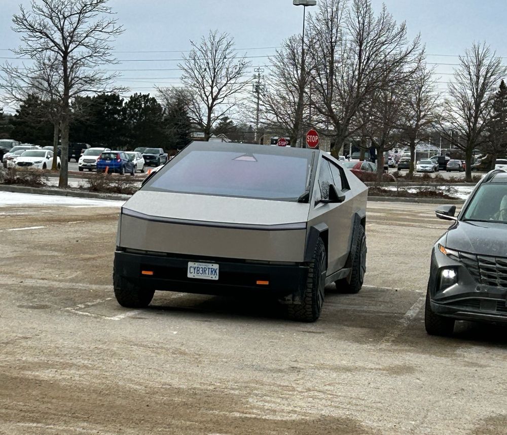 Cyber truck with a license plate that says CYB3RTRK