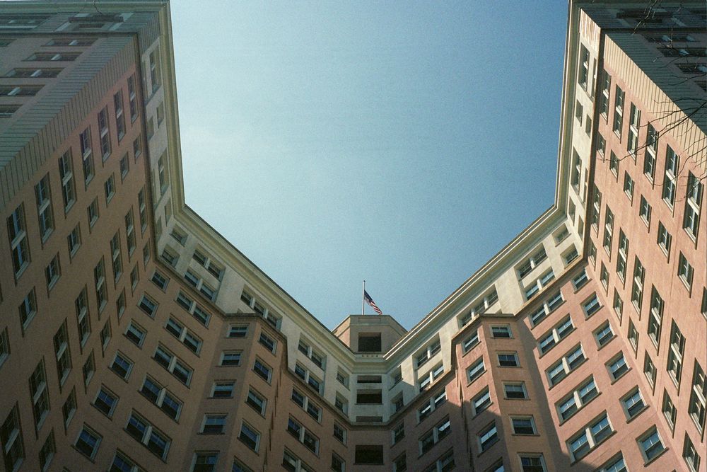 looking up towards the sky of the pink edgewater apartment building