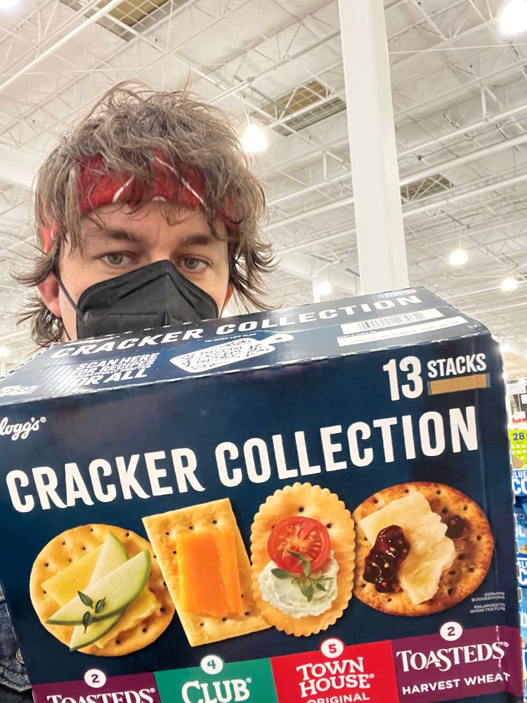 me holding a box that says cracker collection 