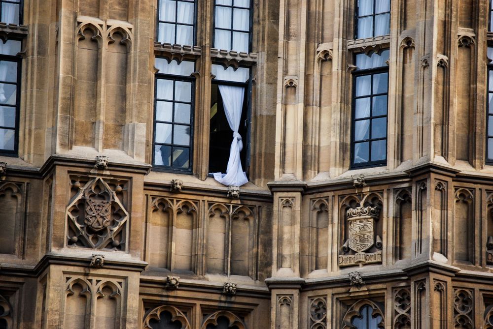 a window drape hangs in the window of westminster palace