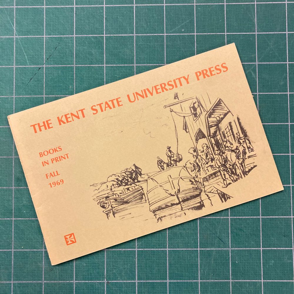 Catalog with text "THE KENT STATE UNIVERSITY PRESS
BOOKS IN PRINT
FALL
1969" on a cutting board background.