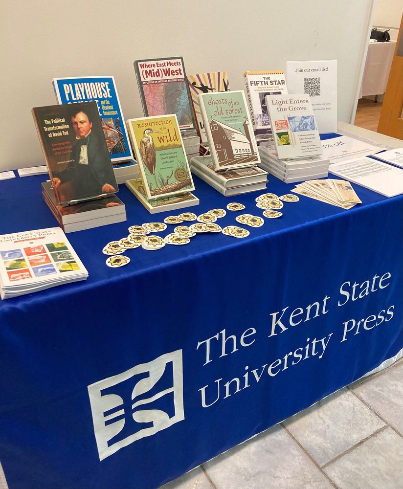 Display of books on stands at a conference exhibit, with Kent State University Press drape.