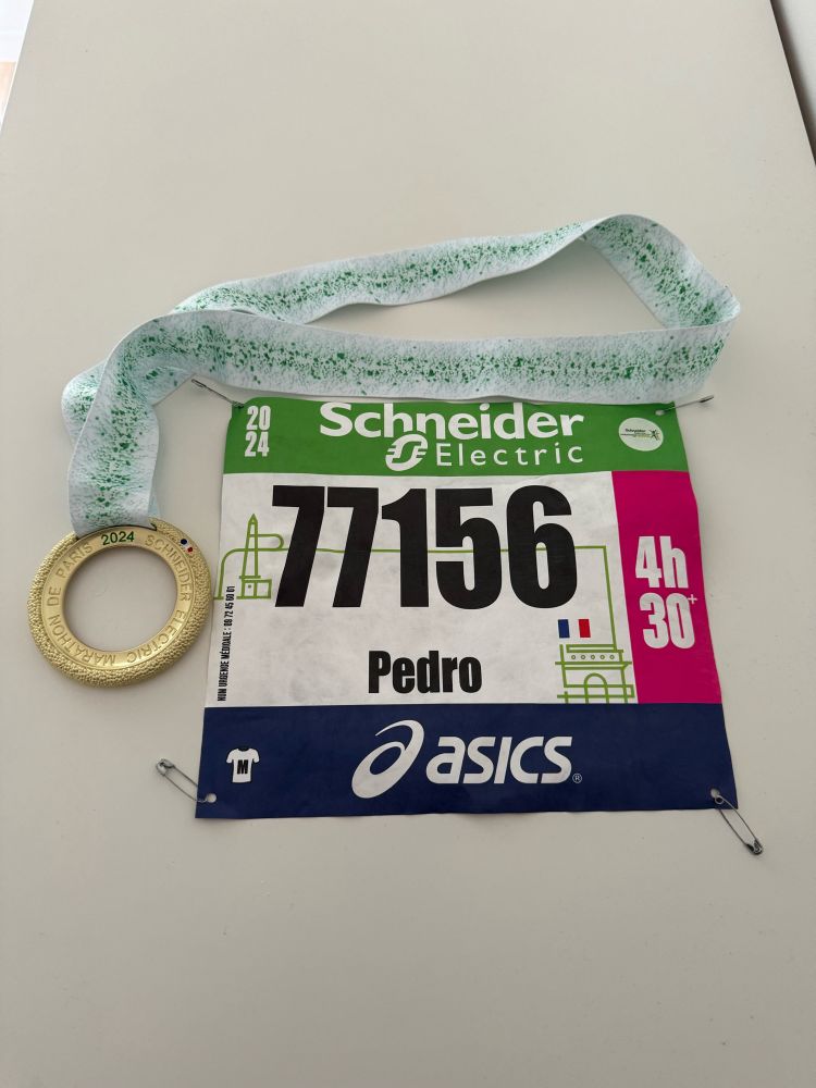 Pedro’s medal and bib (number 77156) for the Paris Marathon.