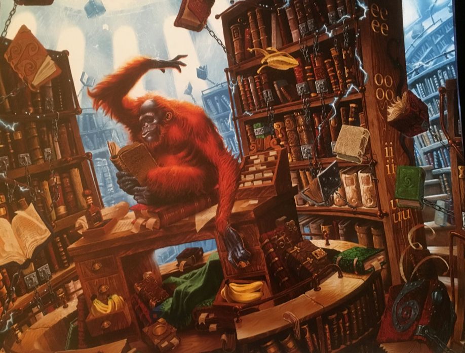 The Unseen University's librarian, from Terry Pratchett's Discworld series. Image depicts an Orang-Utan seated upon a desk, reading a book he's holding in his feet. his right hand is tossing a banana-skin over his head. Various books, some of which are chained to the shelves, are flying around the image. 