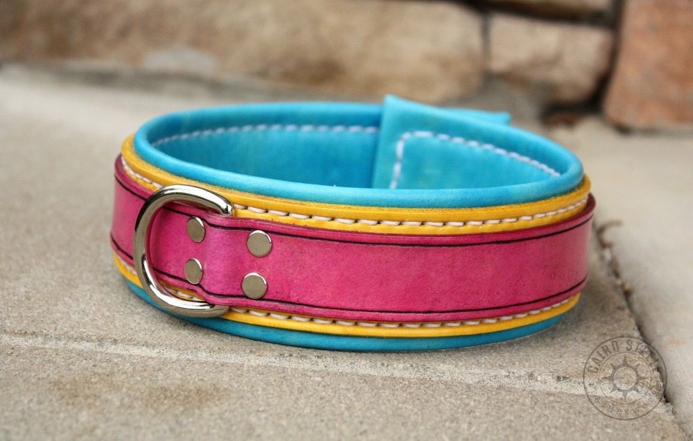 A handmade leather collar in bright pansexual pride colors. The top strap is magenta over a yellow base strap and aqua liner. It has nickel hardware and white stitching.
