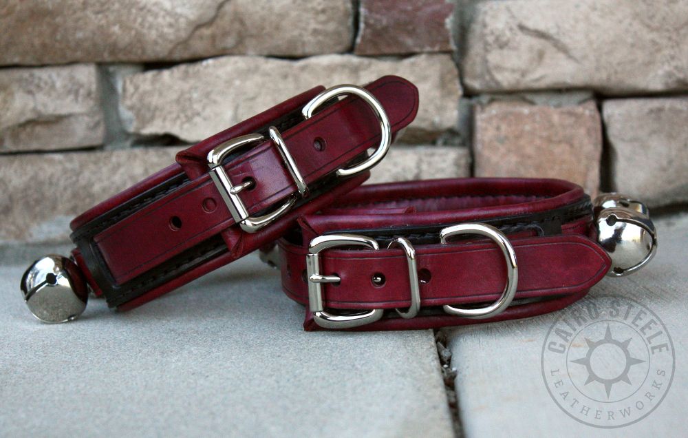 The back sides of the mahogany and black collars, showing the buckle hardware