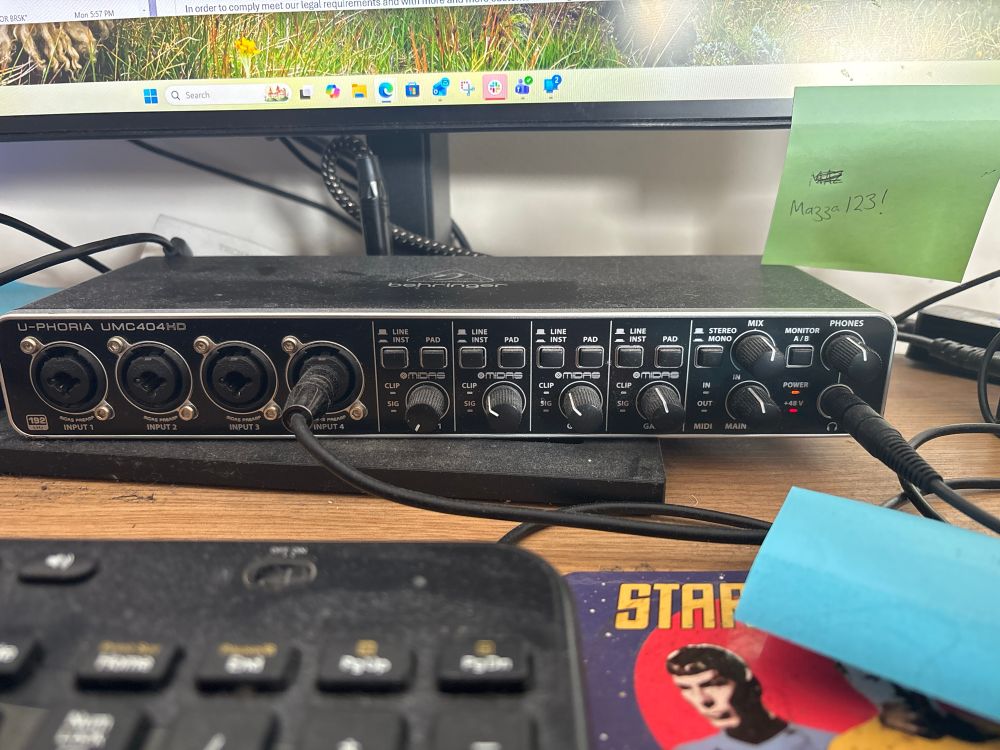 A Behringer audio interface with 4 inputs and many knobs.