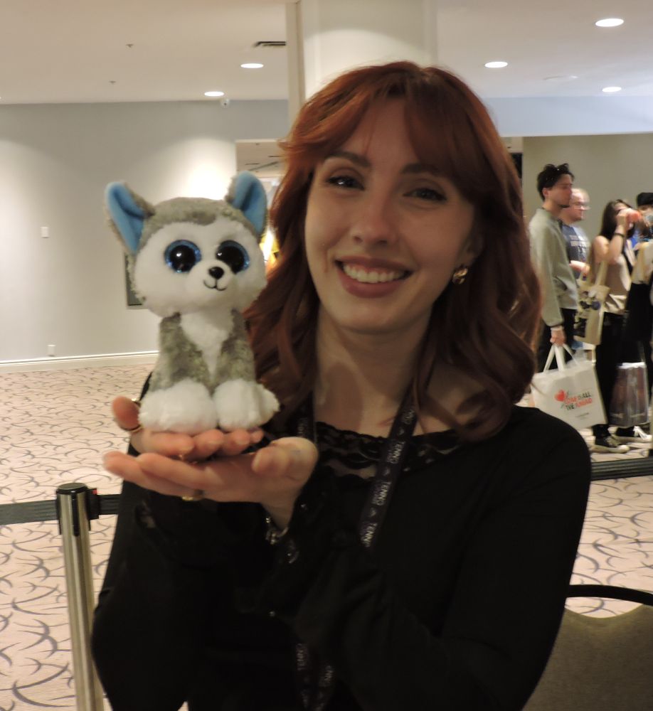 An image of [DE]Megan holding up a plush husky.