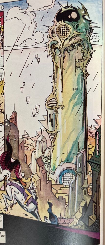 The hero Elric crests the hill in the foreground astride a charging white horse, his red cape billowing behind him, as the last remnants of a rainstorm fall upon the city. Before him the pale green stone of The Tower of Monshanjik rises impossibly tall amongst the surrounding buildings and houses of the city. The tower is cylindrical and phallic, with a large circular portcullis at its base while a globular black dome adorns its top. The upper portion of the tower is encrusted with ornate and spikes and embellishments. The tower as a whole evokes a sense of power and violence. Beyond the tower the shifting, angular walls of The Sea Labyrinth can be seen extending outward across open water. Small ships are traveling towards the entrance of the labyrinth in a scattered formation extending off towards the horizon. Large white clouds traverse the blue sky above.