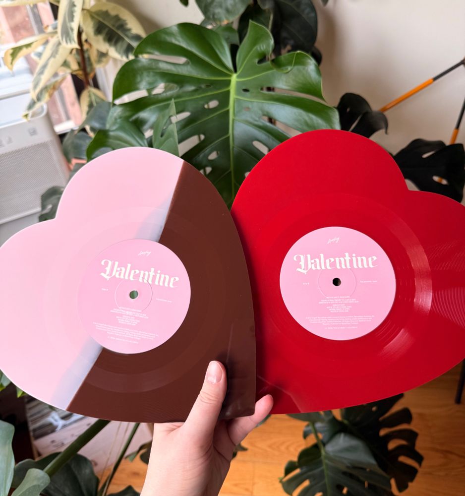 a picture of two heart shaped records, one is a split brown/pink color, one is red