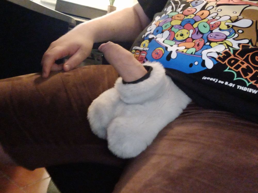 My erect dick with foreskin is poking out of an attached sheath to a brown pair of underwear.