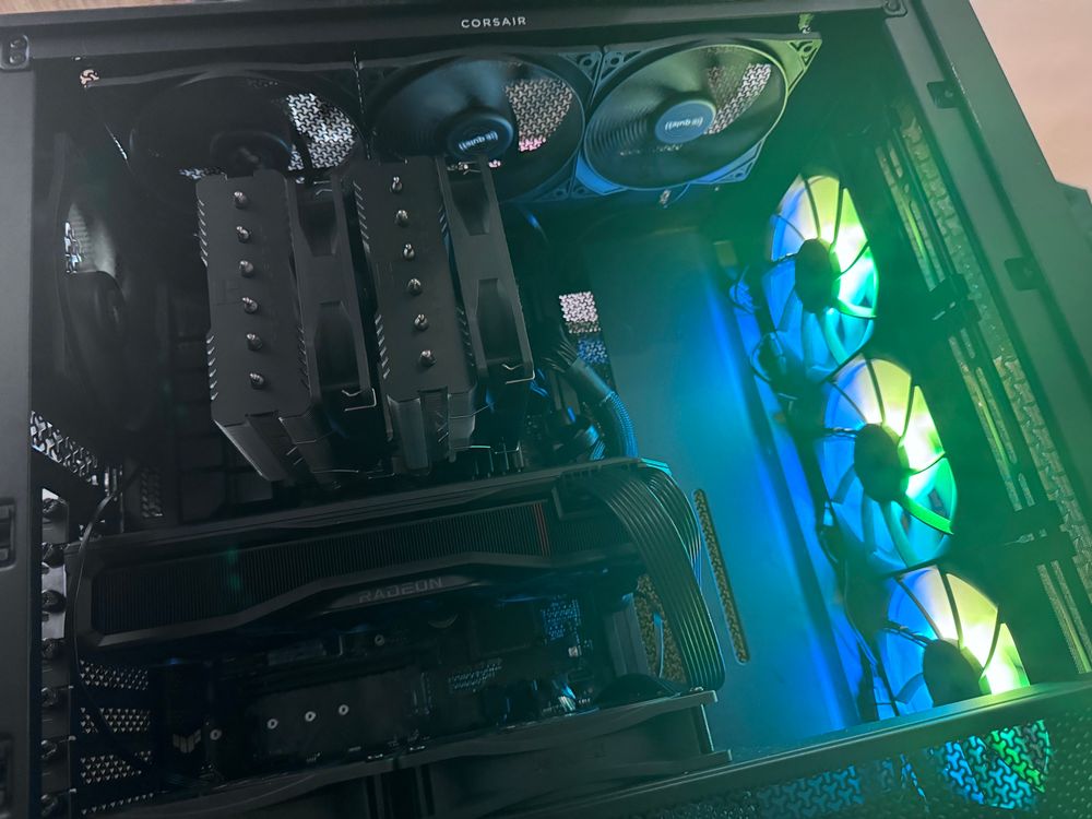 An all black pc build interior with rgb front fans.